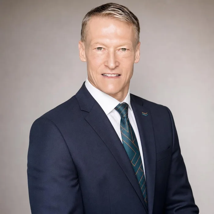 AI-generated LinkedIn headshot of the founder from that exact upload — same face, precisely.